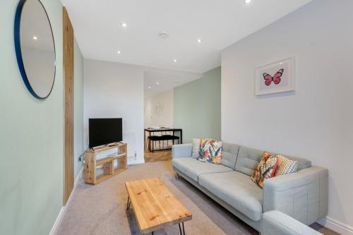 a living room with a couch and a table at Earl Grey at The Tea Warehouse - North East Escapes in Alnwick