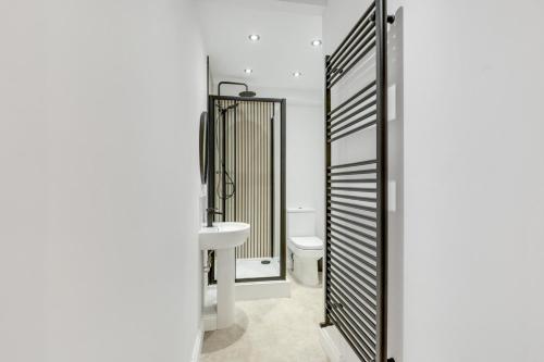 a bathroom with a toilet and a sink at Earl Grey at The Tea Warehouse - North East Escapes in Alnwick