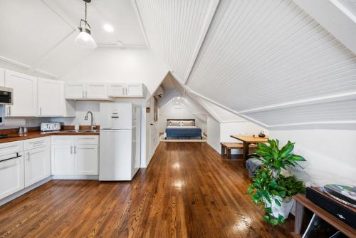 an attic kitchen with white cabinets and a table at The Hidden Hideaway on College in Macon