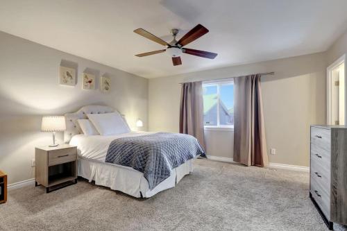 a bedroom with a bed and a ceiling fan at The Eastside Townhome Of Ophir in Anchorage
