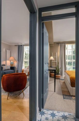 a living room with a door open to a bedroom at The Mill Retreat in Stirling