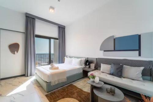 a bedroom with a large bed and a couch at 017 - Mag 900 in Umm Al Quwain