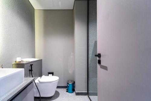 a bathroom with a white toilet and a sink at 017 - Mag 900 in Umm Al Quwain