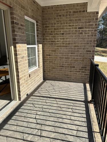 a patio outside of a house with a brick wall at The Bandit Suite in Lexington