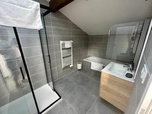 a bathroom with a shower and a sink and a tub at Maison 70 avec 8 chambres lechaffardcom in Satolas-et-Bonce