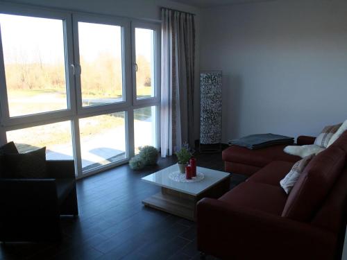 a living room with a couch and a coffee table at Villa Kiek Ut in Trent