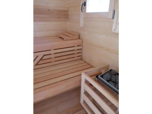 a wooden sauna with wooden flooring in a room at Villa Kiek Ut in Trent