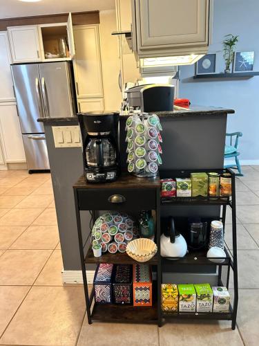 a kitchen with a shelf with food and a refrigerator at South Florida Spacious Oasis 4BR Retreat with 2 King Beds, Amazing Pool, near Beaches in Deerfield Beach