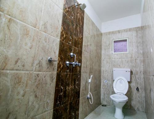 a bathroom with a toilet and a shower at Hotel Akashdeep in Rānchī