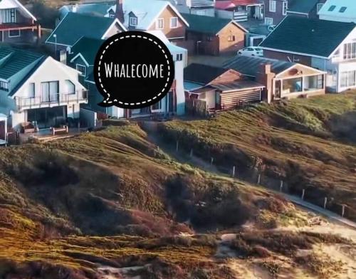 a house on a hill with the words walkalore at Whalecome - Witsand Beachfront House in Witsand