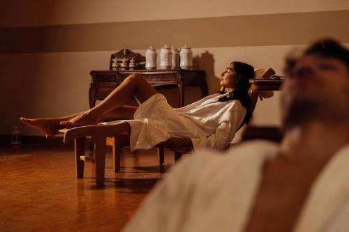 a woman sitting in a chair with her legs crossed at Grand Hotel Telese in Telese