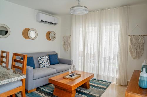 a living room with a couch and a table at Xeliter Green One Playa Dorada in San Felipe de Puerto Plata