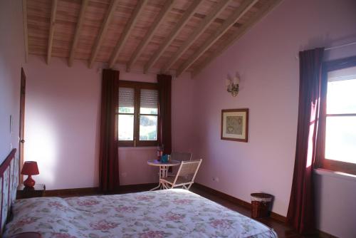 a bedroom with a bed and a table in it at Green and Blue Cottage - Green Room in Ribeira Grande