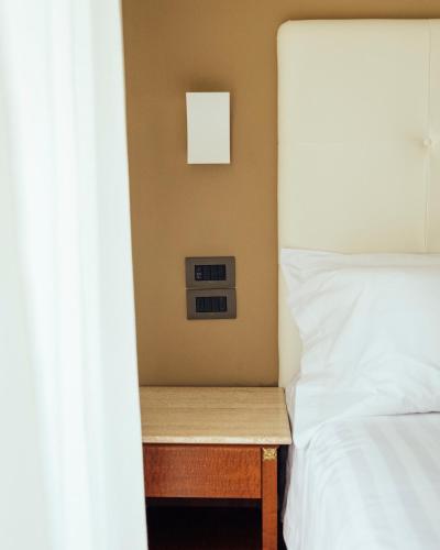 a bedroom with a bed and a night stand next to it at Grand Hotel Telese in Telese