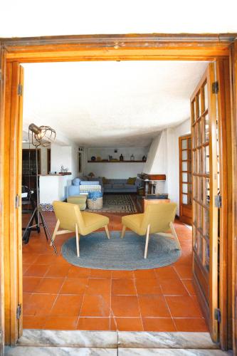a living room with two chairs and a table at Refúgio da Caniçada - T4, Piscina Aquecida (Gerês) in Geres