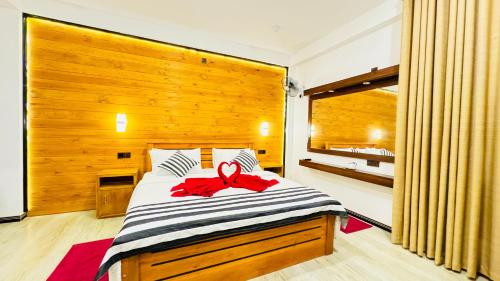 a bedroom with a bed with a red bow on it at Vibe Ella in Ella