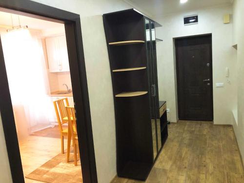 a black book shelf in a room with a door at Апарт-отель "ГАЛАГОВЪ" in Uzhhorod