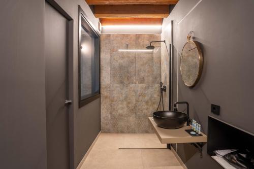 a bathroom with a shower with a bowl on a table at Borgoluna Luxury Holiday House in San Felice del Benaco