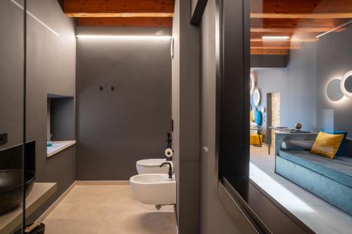 a bathroom with a toilet and a sink at Borgoluna Luxury Holiday House in San Felice del Benaco