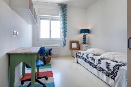 a bedroom with a desk and a bed and a window at Vista mare Charme Apartament in Porto Cesareo