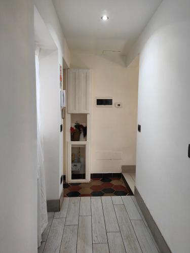 a hallway with white walls and wooden floors and a room at Aparthotel Dei Mercanti in Milan