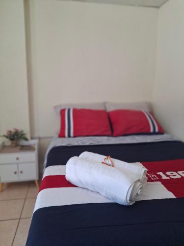 two towels on a bed in a room at Blue Moon Hostel in Antigua Guatemala