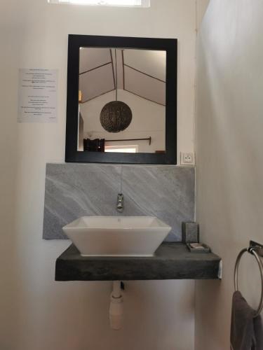 a bathroom sink with a mirror above it at Hebergement Vue Sur Mer in Rodrigues Island