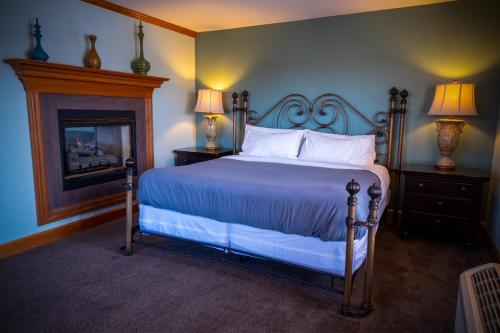 a bedroom with a bed and a fireplace at Nuk's Executive Suites in De Pere