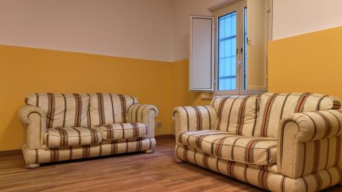 two chairs and a couch in a room at Casa per ferie Maria Ausiliatrice in Rome