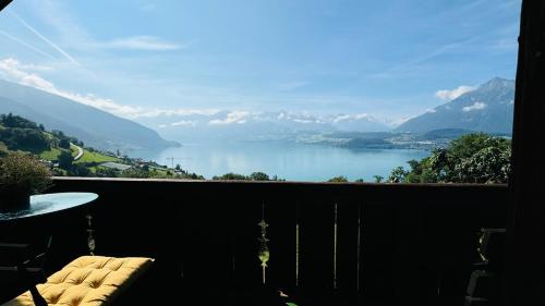 a balcony with a view of a lake and mountains at Ferienwohnung mit fantastischer Aussicht in Aeschlen ob Gunten