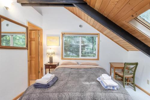 a bedroom with a large bed in a attic at Twin Maples | WiFi, River Access, BBQ in Packwood