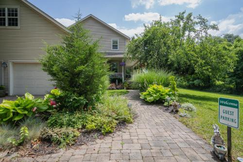 a house with a sign in front of a driveway at Old Town Country Landing in Niagara on the Lake