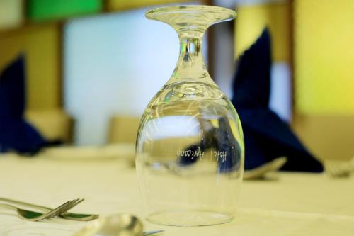 a glass bottle sitting on top of a table at Hotel Africana in Kampala