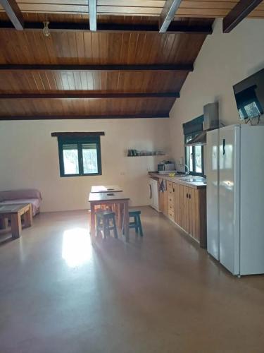a large kitchen with a table and a refrigerator at Modern Villa with Pool in Valleverde, 110 m² in Morón de la Frontera
