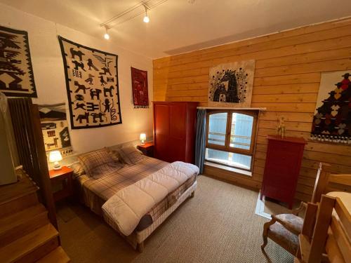 GardonneにあるVaste maison familiale en pierres apparentes PROMO SEPTEMBREのベッドと窓のある寝室