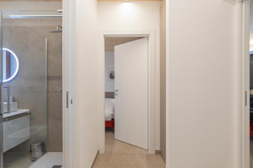 a bathroom with a shower and a glass door at The Nest - TRILO - WIFI - Box - Cortile - Magnolta in Aprica