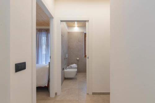 a bathroom with a toilet and a sink at The Nest - TRILO - WIFI - Box - Cortile - Magnolta in Aprica