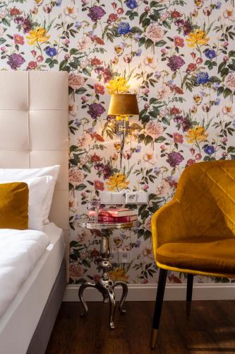 a bedroom with a bed and a table with a lamp at Hotel Linther Hof in Linthe