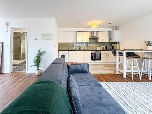 a living room with a couch and a kitchen at Thorpe Road, Norwich in Norwich