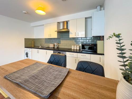 a kitchen with a table and chairs in a room at Thorpe Road, Norwich in Norwich