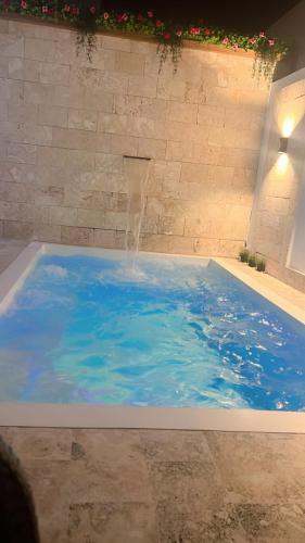 a swimming pool with a water fountain in it at Caribbean Villa 32 Punta Cana in Punta Cana