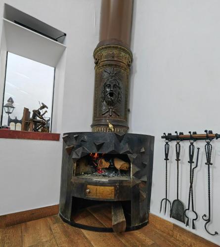 a fireplace in a room with a face on it at Hotel Rumi Punku in Cusco