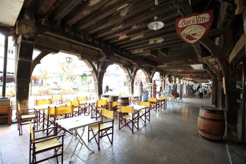 a group of tables and chairs in a building at La Maison des Consuls in Mirepoix