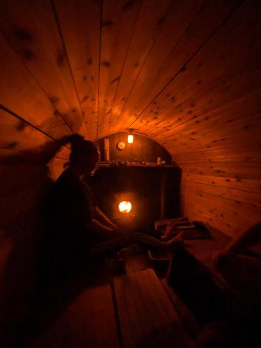 a person in a dark room with a light in a box at あさひシーサイドコテージ in Asahi