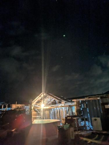 a building with a light on it at night at あさひシーサイドコテージ in Asahi
