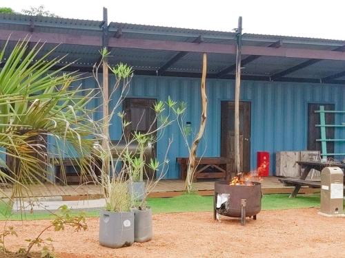 a house with two potted plants in front of it at あさひシーサイドコテージ in Asahi