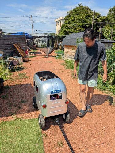a man is standing next to a toy generator at あさひシーサイドコテージ in Asahi