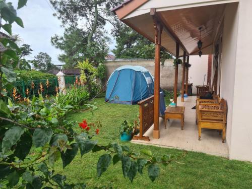 a tent in the backyard of a house at Belgareti Modern Ethnic House Cipanas Puncak in Cibadak