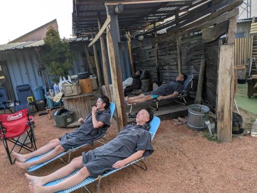 a group of people sitting in lawn chairs at あさひシーサイドコテージ in Asahi