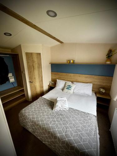a bedroom with a bed with two towels on it at PV70 newquay bay resort in Newquay Bay Resort